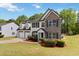 Beautiful two-story home with stone accents, a two-car garage, and professionally landscaped front yard at 3791 Plantation Mill Dr, Buford, GA 30519
