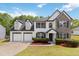 Charming two-story home featuring stone accents, a two-car garage, and a well-manicured front lawn at 3791 Plantation Mill Dr, Buford, GA 30519