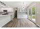Bright, modern kitchen featuring white cabinets, stainless steel appliances, and plenty of counter space at 3791 Plantation Mill Dr, Buford, GA 30519