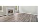 Cozy living room with a fireplace and hardwood floors, creating a warm and inviting atmosphere at 3791 Plantation Mill Dr, Buford, GA 30519