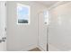 Bright bathroom featuring a glass-enclosed shower and a window providing natural light at 1022 Sutherland Lane (Lot 42), Lawrenceville, GA 30043
