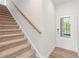 Inviting entryway featuring hardwood floors, a staircase, and a door with glass panels at 1022 Sutherland Lane (Lot 42), Lawrenceville, GA 30043