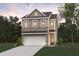Charming two-story home featuring a two-car garage, brick accents, and a well-manicured lawn at 1022 Sutherland Lane (Lot 42), Lawrenceville, GA 30043