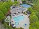 Aerial view showcases community pool, tennis courts, clubhouse and surrounding lush greenery at 331 Spotted Ridge Cir, Woodstock, GA 30188