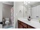 Second bathroom featuring white counter top, brown vanity, and a floral shower curtain at 331 Spotted Ridge Cir, Woodstock, GA 30188