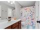 Bathroom featuring floral shower curtain, wood cabinets, vanity, and a sink at 331 Spotted Ridge Cir, Woodstock, GA 30188