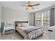 Bright bedroom featuring a ceiling fan, and a patterned duvet cover at 331 Spotted Ridge Cir, Woodstock, GA 30188