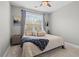 Cozy bedroom with a ceiling fan, large window, and neutral decor provides a relaxing retreat at 331 Spotted Ridge Cir, Woodstock, GA 30188