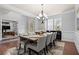 Sophisticated dining area with hardwood floors, a stylish chandelier, and an adjacent living space at 331 Spotted Ridge Cir, Woodstock, GA 30188