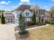 Stunning home with a three-car garage, manicured lawn, and charming front porch at 331 Spotted Ridge Cir, Woodstock, GA 30188