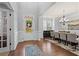 Inviting foyer with hardwood floors, wainscoting, and a view into the dining room at 331 Spotted Ridge Cir, Woodstock, GA 30188