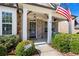 Charming front porch with a welcoming door and American flag, complemented by well-maintained landscaping at 331 Spotted Ridge Cir, Woodstock, GA 30188