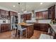 Stylish kitchen with stainless steel appliances, granite countertops, dark wood cabinets, and island seating at 331 Spotted Ridge Cir, Woodstock, GA 30188