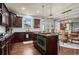 Modern kitchen with stainless steel appliances, granite countertops, dark wood cabinets, and kitchen island at 331 Spotted Ridge Cir, Woodstock, GA 30188