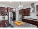 Beautiful kitchen features granite countertops, stainless steel appliances, and modern lighting fixtures at 331 Spotted Ridge Cir, Woodstock, GA 30188