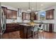Modern kitchen with stainless steel appliances, granite countertops, dark wood cabinets and kitchen island at 331 Spotted Ridge Cir, Woodstock, GA 30188