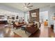 Bright living room features leather sofas, stone fireplace, hardwood floors, and open floor plan at 331 Spotted Ridge Cir, Woodstock, GA 30188