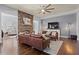 Spacious living room with a stone fireplace, hardwood floors, and comfortable leather furniture at 331 Spotted Ridge Cir, Woodstock, GA 30188