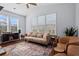 Bright living room featuring large windows, hardwood floors, comfortable sofa and armchairs at 331 Spotted Ridge Cir, Woodstock, GA 30188