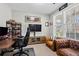 Cozy home office with natural light, a comfortable leather couch, and a well-organized workspace at 331 Spotted Ridge Cir, Woodstock, GA 30188