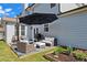 Outdoor patio features wicker seating, an umbrella, a grill, and a small garden at 331 Spotted Ridge Cir, Woodstock, GA 30188