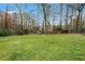 Large backyard with mature trees and a storage shed, offering plenty of room to roam at 4646 Mountain Creek Ne Dr, Roswell, GA 30075