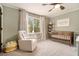 A Bedroom room with a crib, chair, window, and a bookshelf at 4646 Mountain Creek Ne Dr, Roswell, GA 30075