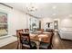 Elegant dining room with a wooden table, chandelier, and lots of natural light at 4646 Mountain Creek Ne Dr, Roswell, GA 30075