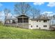 Back of home features spacious deck and screened porch, ideal for outdoor entertaining at 4646 Mountain Creek Ne Dr, Roswell, GA 30075