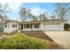 Charming one-story home with a two-car garage, black shutters, and manicured landscaping at 4646 Mountain Creek Ne Dr, Roswell, GA 30075