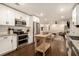 Stylish kitchen with white cabinets, stainless steel appliances, granite countertops, and hardwood floors at 4646 Mountain Creek Ne Dr, Roswell, GA 30075
