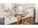 Bright kitchen with white cabinets, stainless steel sink, granite countertops, and hardwood floors at 4646 Mountain Creek Ne Dr, Roswell, GA 30075