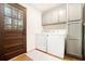 This laundry room has a washer, dryer, and cabinet space for convenience at 4646 Mountain Creek Ne Dr, Roswell, GA 30075