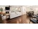 Open concept living room with hardwood floors, fireplace, dining area, and access to the kitchen at 4646 Mountain Creek Ne Dr, Roswell, GA 30075