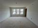 Bedroom with three bright windows overlooking neighborhood at 5114 Arista Dr, Douglasville, GA 30135
