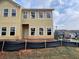 Tan two-story home with a shingle accent and large windows throughout the exterior of the building at 5114 Arista Dr, Douglasville, GA 30135