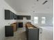 Unfinished kitchen featuring gray cabinets, white walls, and an unfinished island in an open layout concept at 5114 Arista Dr, Douglasville, GA 30135