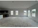 Unfinished living room featuring many large windows with an attached kitchen featuring gray cabinets at 5114 Arista Dr, Douglasville, GA 30135