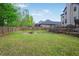 Spacious backyard with green grass, a privacy fence and multiple tiers at 527 Mossycup Dr, Fairburn, GA 30213