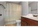 Bathroom with a vanity, mirror and a shower with a neutral striped shower curtain at 527 Mossycup Dr, Fairburn, GA 30213