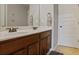 Bathroom featuring a double vanity with wood cabinets and two large mirrors at 527 Mossycup Dr, Fairburn, GA 30213