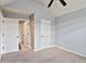 Bright bedroom with neutral walls, multiple closets, and a ceiling fan at 527 Mossycup Dr, Fairburn, GA 30213