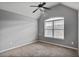 This bedroom features a window, neutral colored carpet, and a ceiling fan at 527 Mossycup Dr, Fairburn, GA 30213