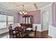 Elegant dining room with coffered ceilings, chandelier, and hardwood floors at 527 Mossycup Dr, Fairburn, GA 30213