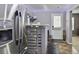 Kitchenette area with stainless steel refrigerator and small bar with additional shelving at 527 Mossycup Dr, Fairburn, GA 30213