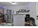 Cozy kitchenette area features stainless steel refrigerator and small bar area at 527 Mossycup Dr, Fairburn, GA 30213