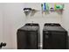 A laundry room featuring black Samsung washing machine and a dryer at 527 Mossycup Dr, Fairburn, GA 30213