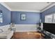 Blue living room with hardwood floors and two-tone paint at 527 Mossycup Dr, Fairburn, GA 30213