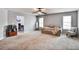 Spacious living room with neutral walls and carpet, and many windows at 527 Mossycup Dr, Fairburn, GA 30213