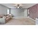 Open living room with cozy seating and view of additional room at 527 Mossycup Dr, Fairburn, GA 30213